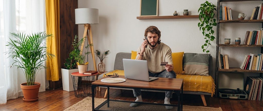 Person on a phone call reviewing a credit card statement during a credit card rate negotiation