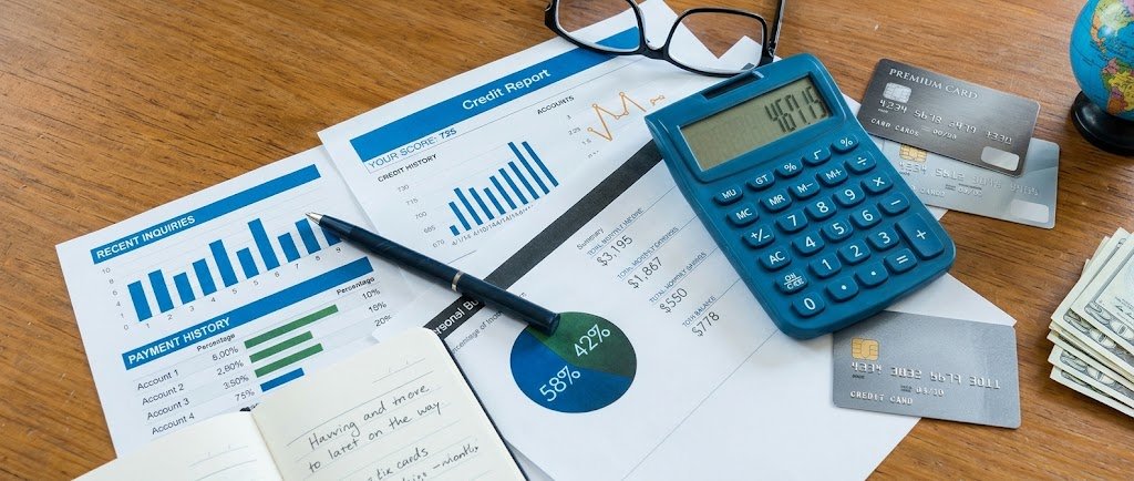 Credit card and calculator on a desk illustrating a credit card limit increase and its effect on a credit score