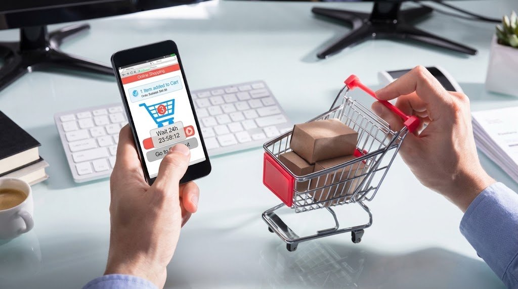 Person pausing before completing an online purchase, illustrating the 24-hour rule for spending