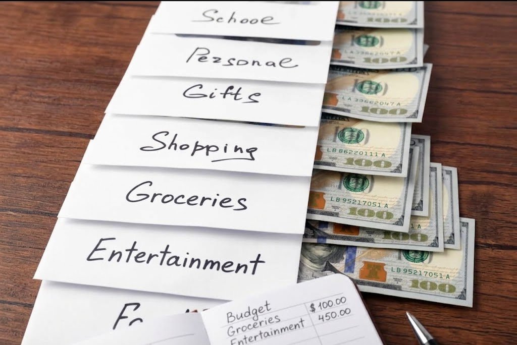 Cash stuffing method envelopes filled with money divided into budget categories like groceries and entertainment
