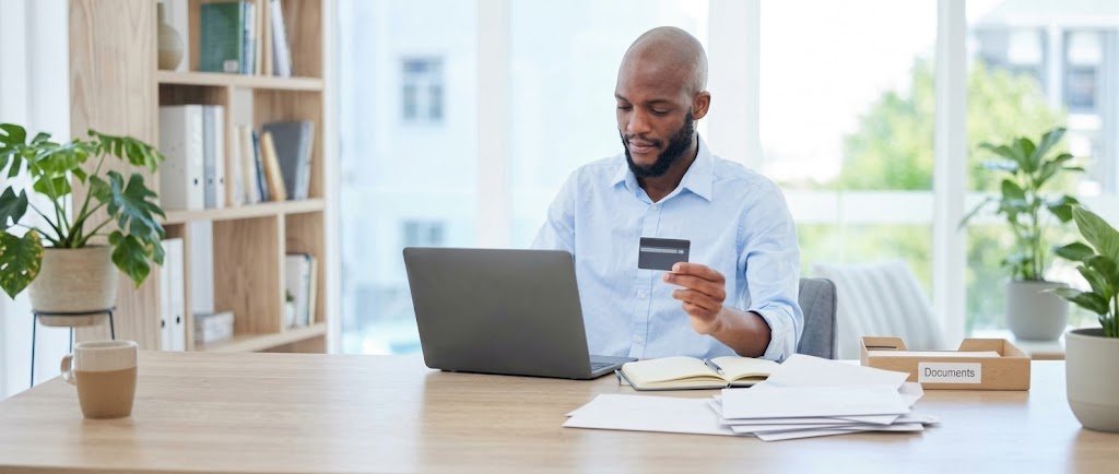 Person comparing credit card prequalification and pre-approval offers on a laptop before applying