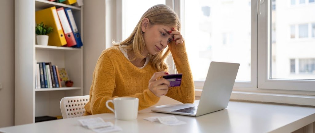 Person comparing multiple credit card statements against a debt consolidation loan offer