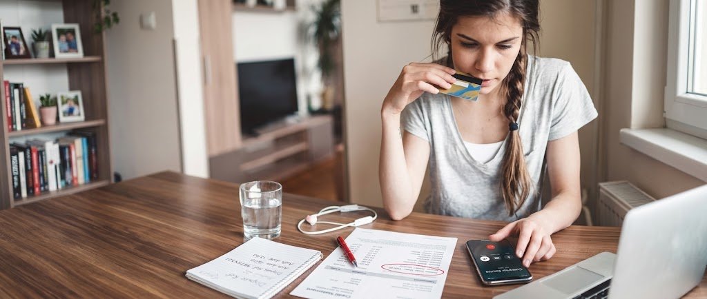 Person comparing a chargeback vs refund process while reviewing a credit card statement