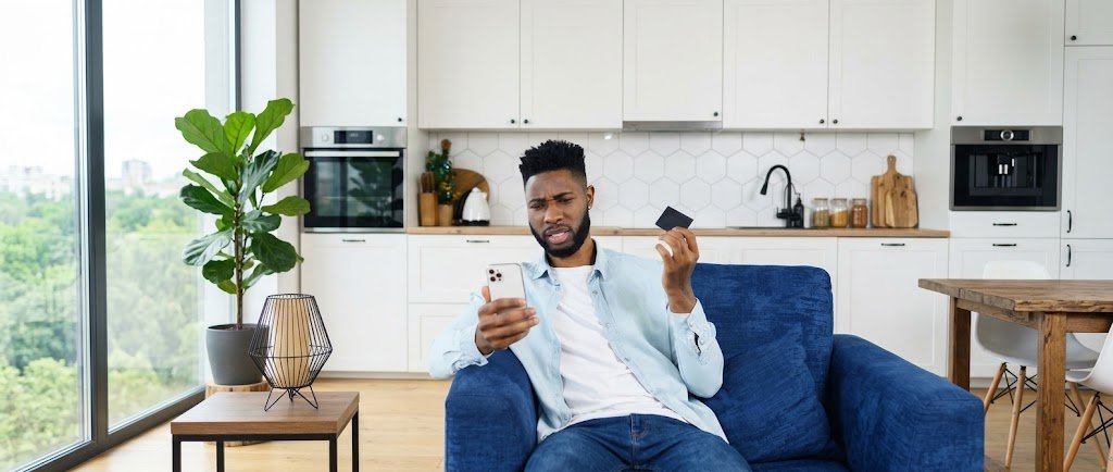 Person checking their credit score dropped after paying off a credit card in full