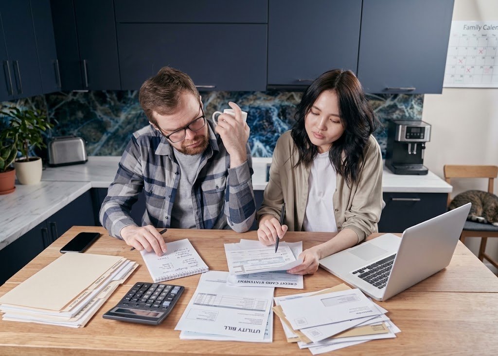 how to protect your money from inflation — family reviewing budget in 2026