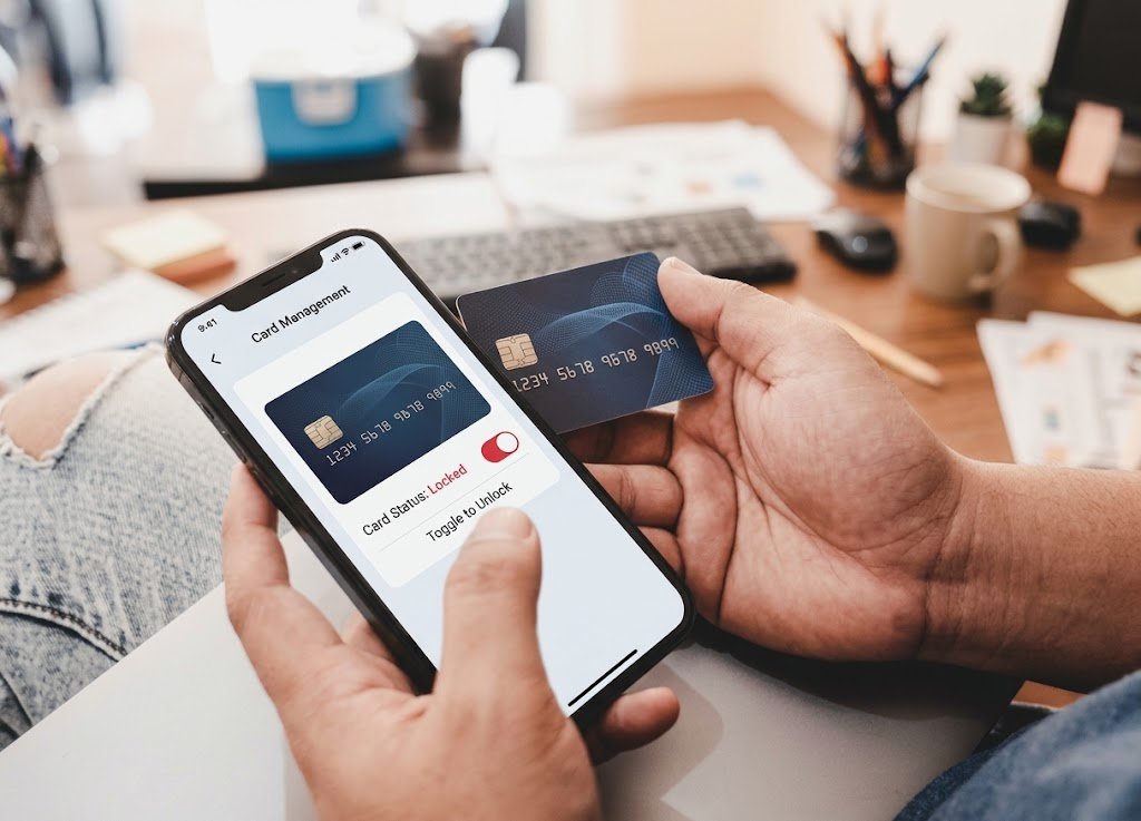 Person using a credit card lock feature in a banking app on a smartphone