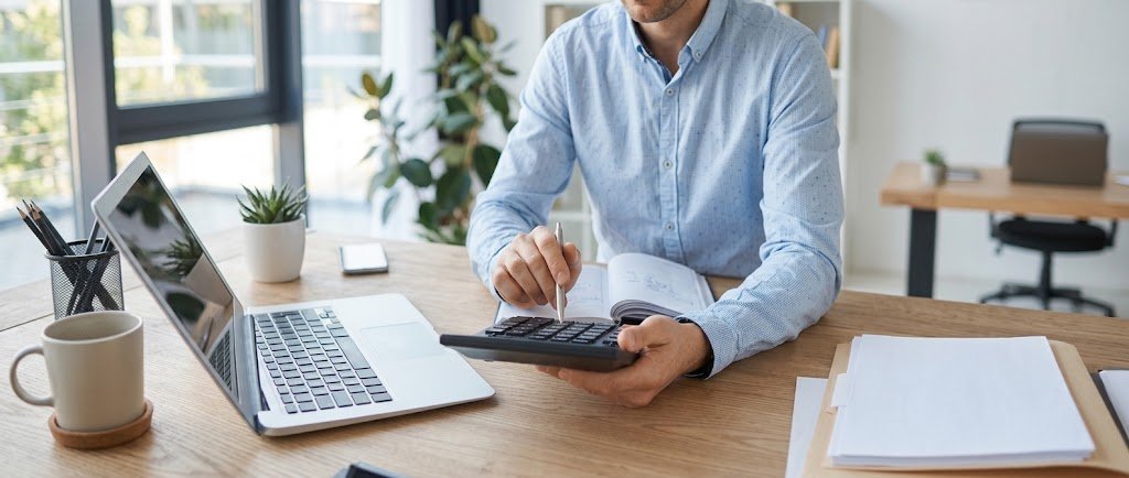 Person reviewing loan rate shopping offers on a laptop while comparing rates and fees