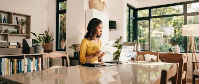Freelancer reviewing self-employed retirement plans on a laptop at a home office desk