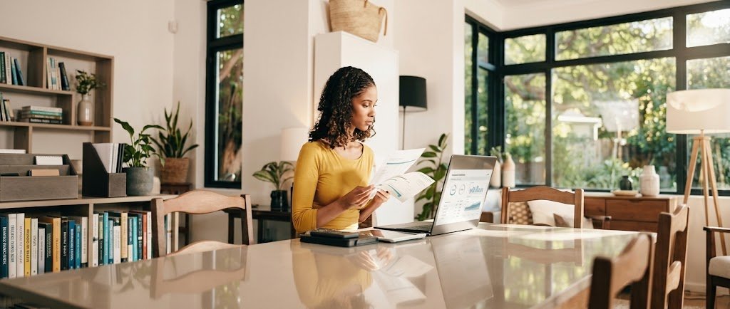 Freelancer reviewing self-employed retirement plans on a laptop at a home office desk