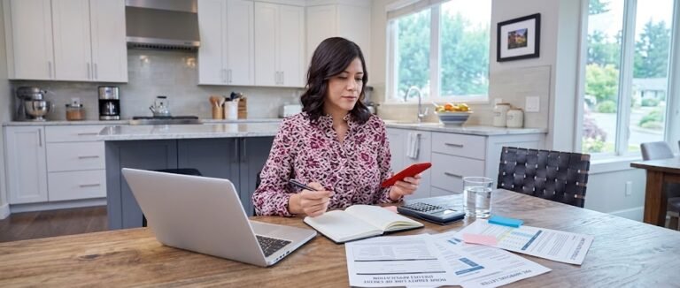 Homeowner reviewing documents for a loan against property with a calculator and house keys on the table