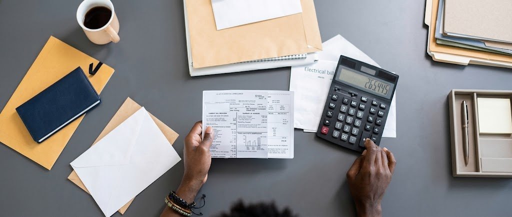 Person building a tax refund plan with a bonus pay stub, refund notice, and calculator