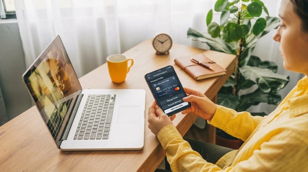 Person reviewing a credit card EMI installment plan on a smartphone before converting a laptop purchase