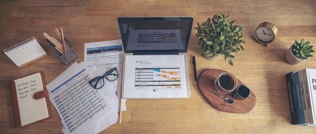 Laptop displaying a personal finance dashboard in Google Sheets with budget charts and savings tracker