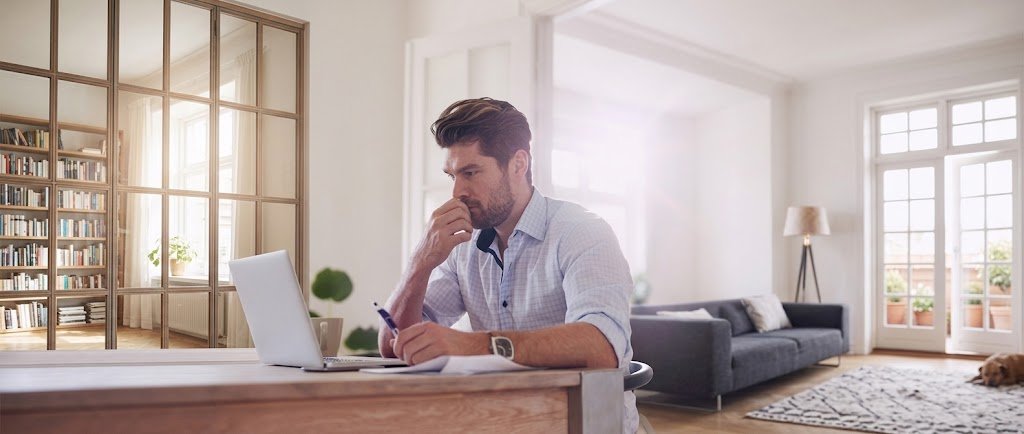 Person checking credit monitoring alerts and a credit report on a laptop