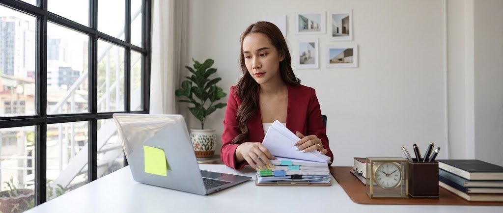 Borrower reviewing a loan closure checklist and paid-in-full letter at a desk