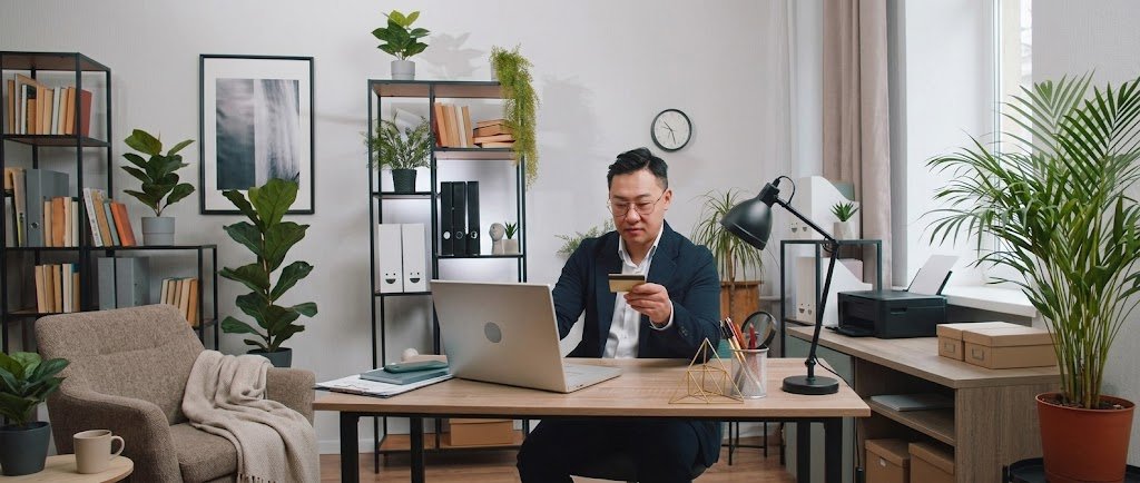 Freelancer reviewing income records on a laptop while applying for a credit card for freelancers