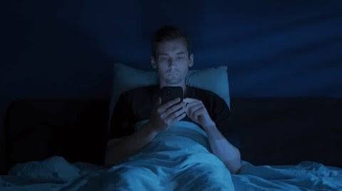 Tired shopper scrolling a phone at night, showing how decision fatigue leads to money mistakes